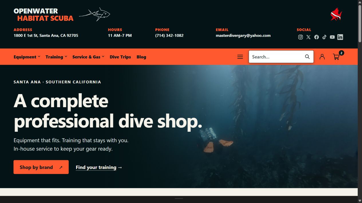 The Openwater Habitat desktop homepage, with a contact strip, shop and training navigation, and an underwater hero